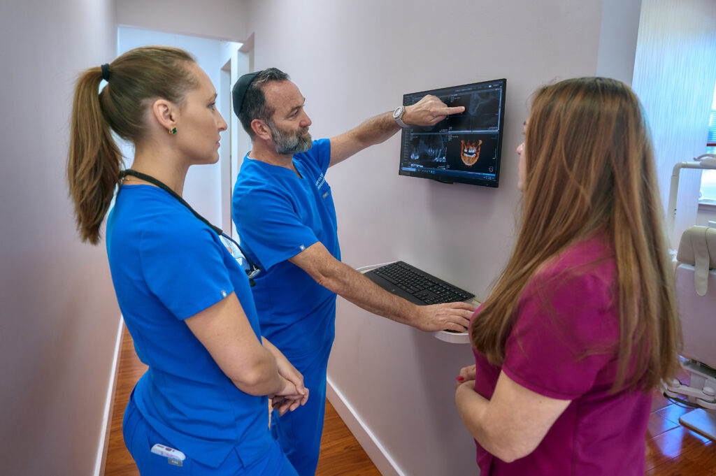 Dr. Burdo and fellow dentists reviewing a CBCT (Cone Beam Computed Tomography)