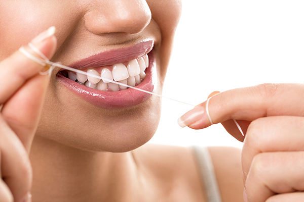 Close-up image of woman flossing