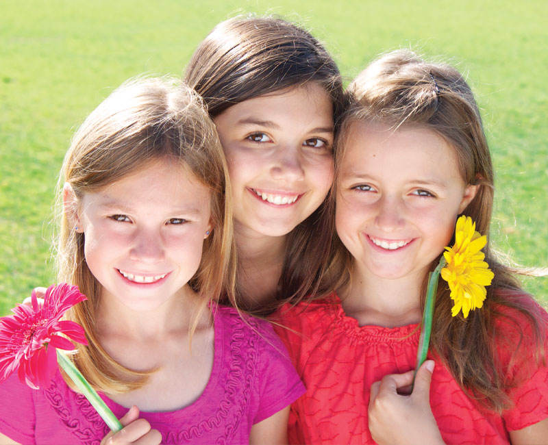 three girls with flowers